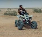Dynamic shot of a person enjoying quad biking in Riyadh's desert landscape.